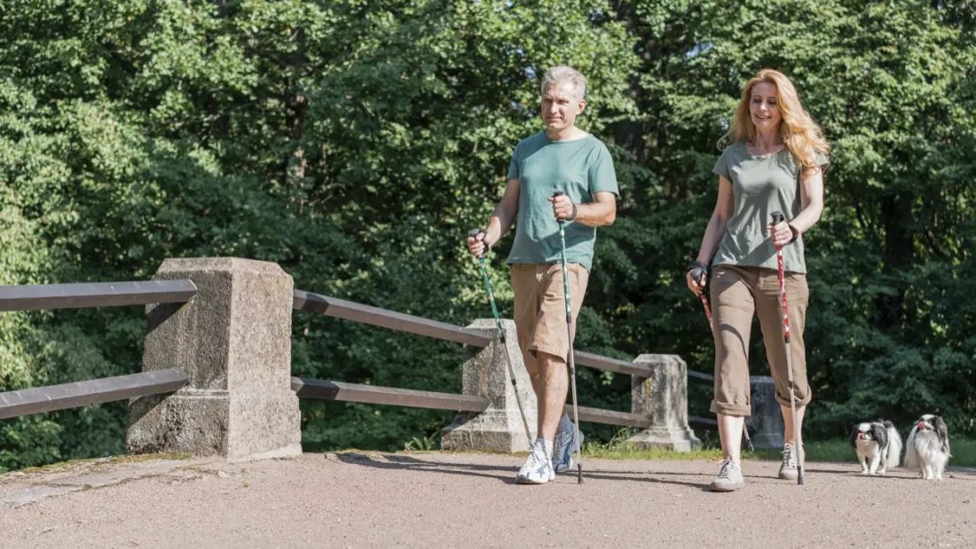 Walking outdoors in a park for daily activity.