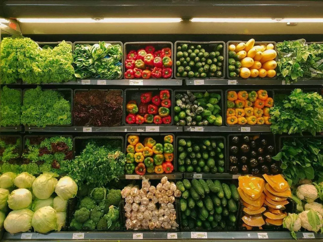 Fresh produce in a grocery aisle.