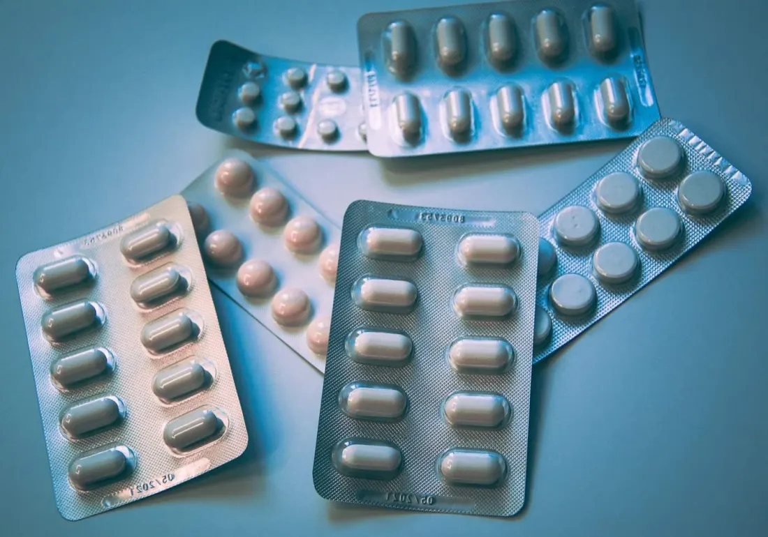 Medication blister packs on a clinical surface.